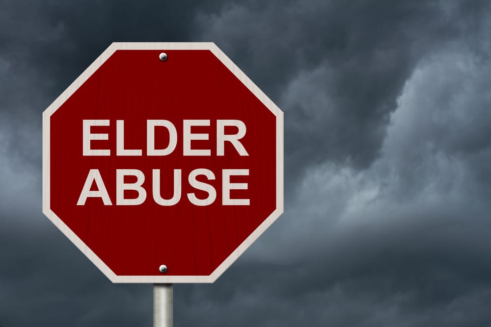 stop sign with elder abuse written on it